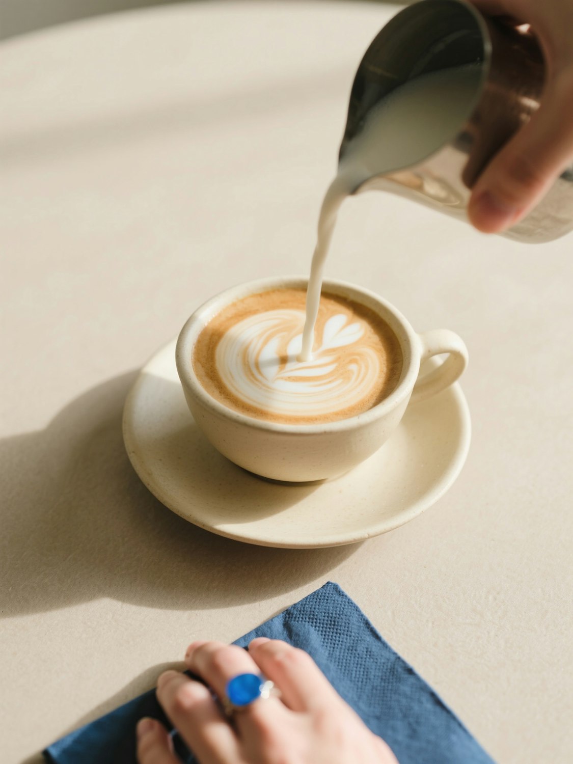 Pouring latte art into a cup